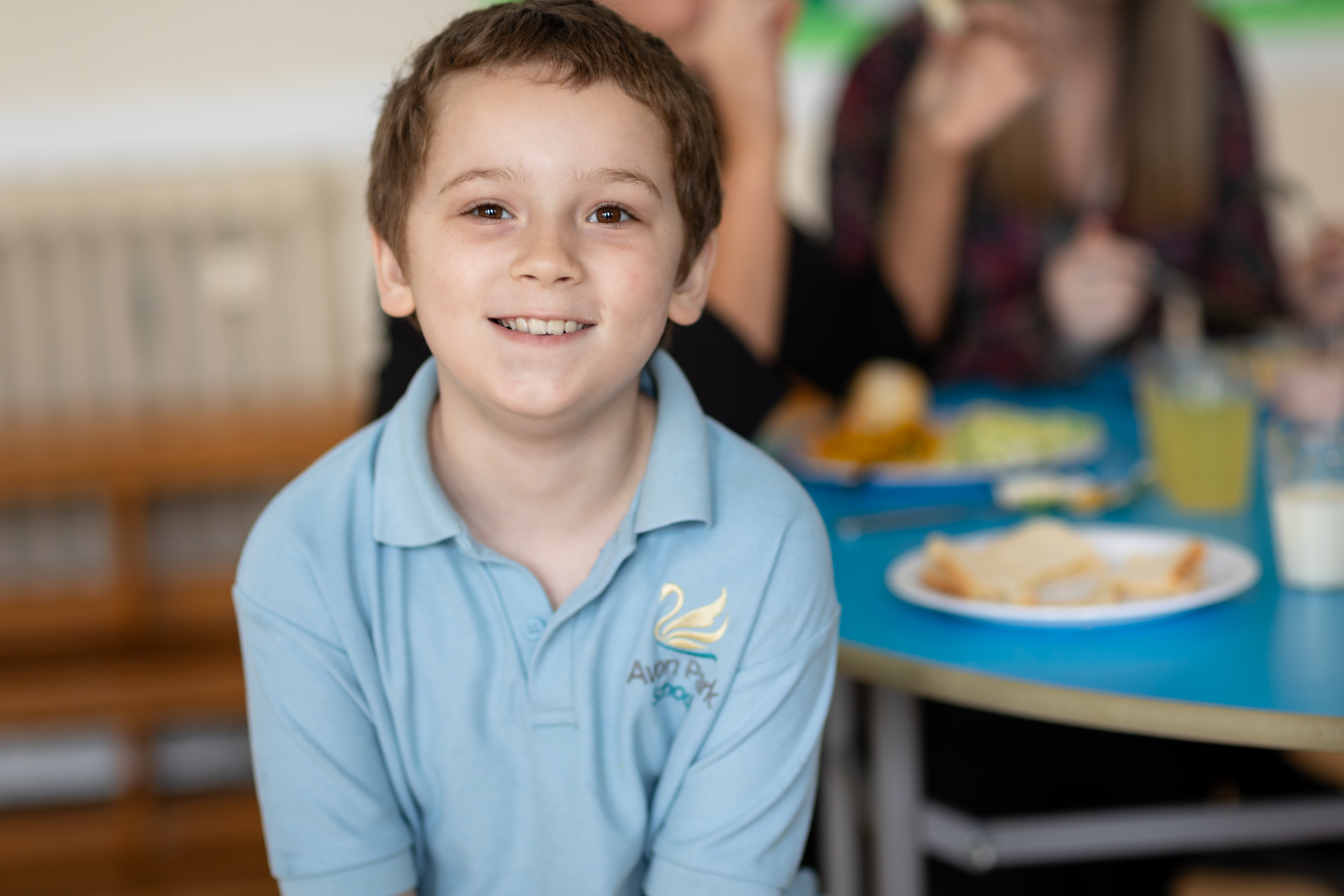 A young boy with brown hair at Avon Park School smiling at the camera
